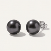 A pair of 9mm bold round black pearl stud earrings with silver posts, shown on a light beige background 