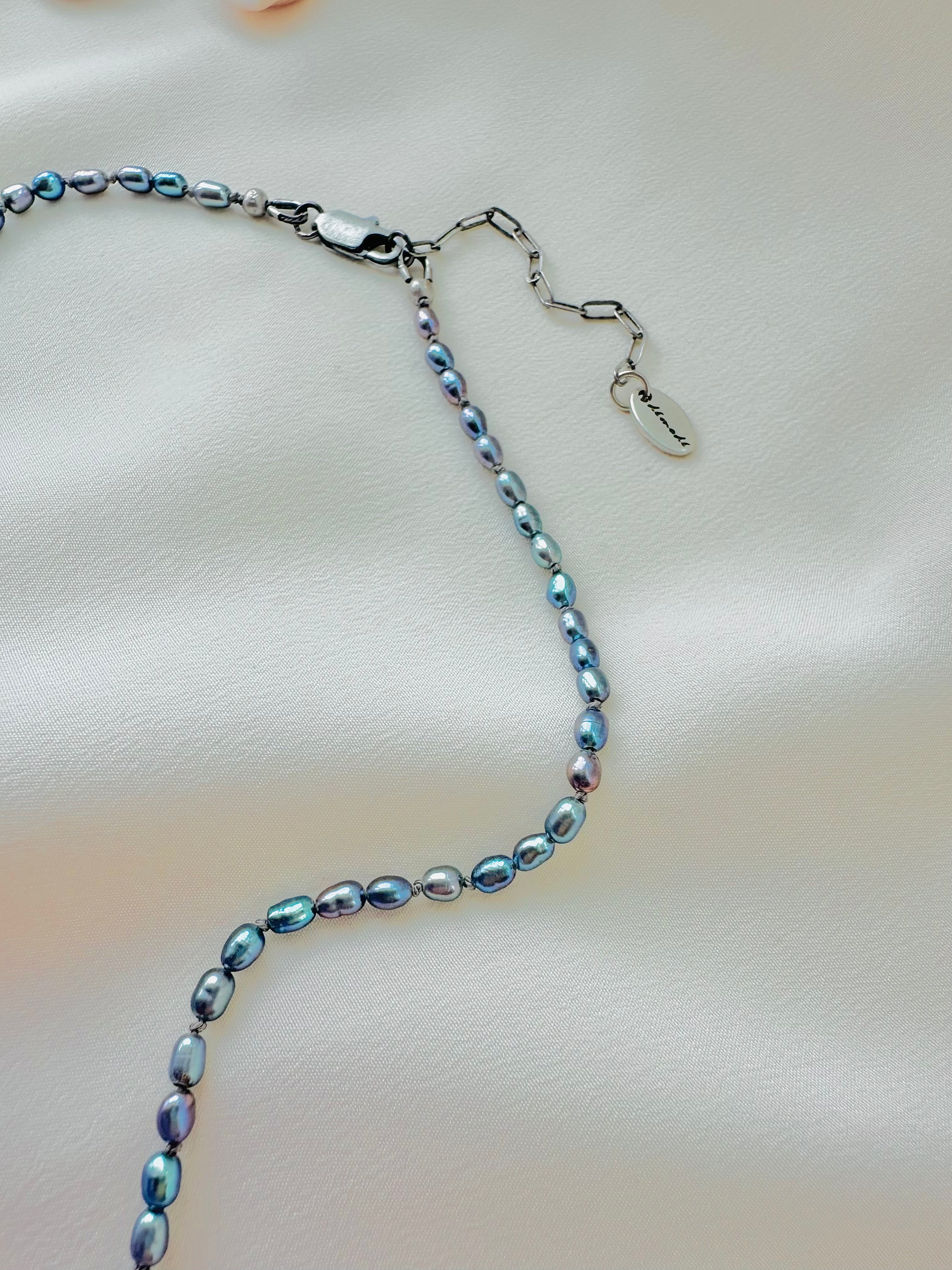 Necklace with blue and silver beads on a light background