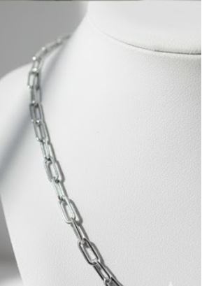 Silver chain necklace on a mannequin bust against a neutral background