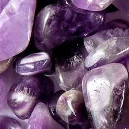 Close-up of purple and gray tumbled amethyst stones